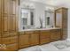 Spacious bathroom features double vanities, wooden cabinets, granite counters, and recessed lighting at 7648 Killarney Dr, Indianapolis, IN 46217