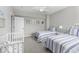 Comfortable bedroom featuring twin beds, soft natural light, and a cute baby crib at 7648 Killarney Dr, Indianapolis, IN 46217