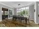 Bright dining area with large windows, hardwood floors, and access to an outdoor patio at 7648 Killarney Dr, Indianapolis, IN 46217