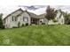 Well-maintained brick home with lush green lawn, mature trees, and classic architectural details at 7648 Killarney Dr, Indianapolis, IN 46217