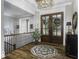 Elegant foyer with hardwood floors, large glass doors, and stylish decor create a welcoming entrance at 7648 Killarney Dr, Indianapolis, IN 46217