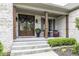 Inviting front porch with elegant double doors, decorative wreaths, and comfortable seating area at 7648 Killarney Dr, Indianapolis, IN 46217