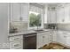Kitchen showcases granite counters, white cabinetry, stainless dishwasher, and a view from over the sink at 7648 Killarney Dr, Indianapolis, IN 46217