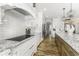 Spacious kitchen boasts granite countertops, white cabinets, stainless appliances, and hardwood flooring at 7648 Killarney Dr, Indianapolis, IN 46217