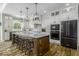 A contemporary kitchen with a large island, modern appliances, white cabinets, and wooden floors at 7648 Killarney Dr, Indianapolis, IN 46217