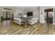 Bright, open-concept living room features hardwood floors, exposed brick, and contemporary furnishings at 7648 Killarney Dr, Indianapolis, IN 46217