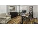 Home office with hardwood floors, a large desk, comfortable seating, and natural light at 7648 Killarney Dr, Indianapolis, IN 46217