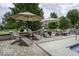 A gorgeous pool patio featuring umbrella-covered seating, perfect for lounging by the in-ground pool at 7648 Killarney Dr, Indianapolis, IN 46217