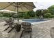 Inviting poolside patio with comfortable seating and umbrellas overlooks the sparkling in-ground pool at 7648 Killarney Dr, Indianapolis, IN 46217