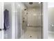 Luxurious tiled shower features a rainfall shower head, handheld sprayer, and built-in bench at 7648 Killarney Dr, Indianapolis, IN 46217