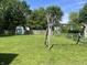 Expansive backyard featuring a swing set, storage shed, and lush green lawn at 7824 Hearthstone Way, Indianapolis, IN 46227