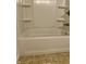 Bathroom showing a tiled tub with a shower head and white walls at 7824 Hearthstone Way, Indianapolis, IN 46227