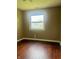 Bright bedroom with wood floors, neutral walls, and a large window at 7824 Hearthstone Way, Indianapolis, IN 46227