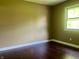 Bedroom featuring wood floors, neutral colored walls, and a sunny window at 7824 Hearthstone Way, Indianapolis, IN 46227
