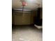 A look inside the garage with a garage door, overhead lighting, and a furnace at 7824 Hearthstone Way, Indianapolis, IN 46227