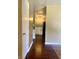 Hallway with hardwood floors offers a view of the kitchen at the end at 7824 Hearthstone Way, Indianapolis, IN 46227
