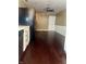 Open kitchen view with hardwood floors, white trim, and white door to the outside at 7824 Hearthstone Way, Indianapolis, IN 46227