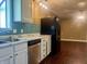 Well-lit kitchen with marble countertops, blue tiled backsplash, and stainless steel appliances at 7824 Hearthstone Way, Indianapolis, IN 46227