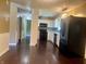 Modern kitchen with dark appliances, white cabinets, and stylish light fixtures at 7824 Hearthstone Way, Indianapolis, IN 46227