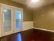 Room with access to outdoor space with hardwood floors and neutral colored walls at 7824 Hearthstone Way, Indianapolis, IN 46227