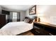 Bedroom with white bedding, artwork, and wood floors at 7831 Eagle Valley Pass, Indianapolis, IN 46214