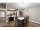 Cozy dining area featuring a wooden table with seating, modern lighting, and a view into the adjacent kitchen at 7831 Eagle Valley Pass, Indianapolis, IN 46214