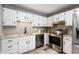 Bright kitchen featuring white cabinets, stainless steel appliances, granite countertops and modern fixtures at 7831 Eagle Valley Pass, Indianapolis, IN 46214