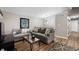 Comfortable living room with neutral tones, modern lighting, stylish furniture, and wood-look flooring at 7831 Eagle Valley Pass, Indianapolis, IN 46214