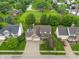 Aerial view of a suburban home with a well-manicured lawn, mature trees, and a long driveway leading to a three-car garage at 7978 Park Meadows Dr, Brownsburg, IN 46112