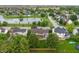 A high-angle aerial view reveals a neighborhood bordering farmland, showcasing homes with green lawns and mature trees at 7978 Park Meadows Dr, Brownsburg, IN 46112