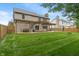 Large backyard with a patio, pergola, basketball hoop and green lawn, ideal for recreation at 7978 Park Meadows Dr, Brownsburg, IN 46112