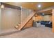 Finished basement with staircase leading to a cozy living area featuring log walls at 7978 Park Meadows Dr, Brownsburg, IN 46112
