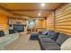 Basement living area with a stone fireplace, built-in bar, and comfortable seating at 7978 Park Meadows Dr, Brownsburg, IN 46112