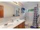Bathroom featuring a double sink vanity, white tiled walls, and a bathtub with shower at 7978 Park Meadows Dr, Brownsburg, IN 46112
