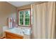 Inviting bathroom featuring a soaking tub, shower, and a large window for natural light at 7978 Park Meadows Dr, Brownsburg, IN 46112