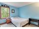 Cozy bedroom with simple decor, natural light from the window, and light blue walls at 7978 Park Meadows Dr, Brownsburg, IN 46112