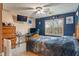 A well-lit bedroom decorated with Indianapolis Colts memorabilia, including a desk and a TV at 7978 Park Meadows Dr, Brownsburg, IN 46112