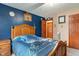 Bedroom with a wooden bedframe, basketball hoop wall decor, and a glimpse into the hallway at 7978 Park Meadows Dr, Brownsburg, IN 46112