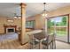 Cozy dining area with sliding doors to the backyard and a view of the living room at 7978 Park Meadows Dr, Brownsburg, IN 46112