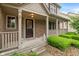 Welcoming front porch with brick accents, decorative columns, and a cozy seating area at 7978 Park Meadows Dr, Brownsburg, IN 46112