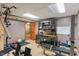 Basement gym area featuring an armoire, exercise equipment, a work area and a door to another room at 7978 Park Meadows Dr, Brownsburg, IN 46112