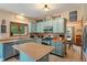 Charming kitchen features blue cabinets, stainless steel appliances, and a cozy island at 7978 Park Meadows Dr, Brownsburg, IN 46112