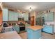 Bright kitchen featuring blue cabinets, stainless steel appliances, and center island at 7978 Park Meadows Dr, Brownsburg, IN 46112
