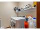 Bright laundry room with floating shelves, plenty of storage, and front-load washer and dryer at 7978 Park Meadows Dr, Brownsburg, IN 46112