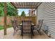 Cozy outdoor patio featuring a dining table set under a charming pergola-covered space and a textured brick surface at 7978 Park Meadows Dr, Brownsburg, IN 46112