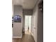 Hallway view featuring modern decor and doorways to various rooms at 8241 Morera Ct, Indianapolis, IN 46237