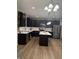 Spacious kitchen with dark cabinets, stainless steel appliances, and a center island at 8241 Morera Ct, Indianapolis, IN 46237