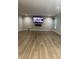 Modern living room with wood floors, a fireplace and wall mounted TV at 8241 Morera Ct, Indianapolis, IN 46237