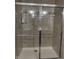 Modern shower stall featuring glass doors, tiled walls, and sleek fixtures at 8241 Morera Ct, Indianapolis, IN 46237