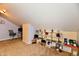 Attic featuring neutral carpet, a desk, and display shelves containing memorabilia at 8325 Chesterhill Ln, Indianapolis, IN 46239